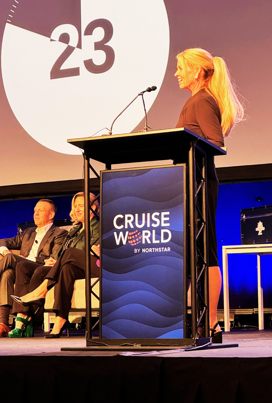 Angela Hughes speaking at CruiseWorld travel industry conference